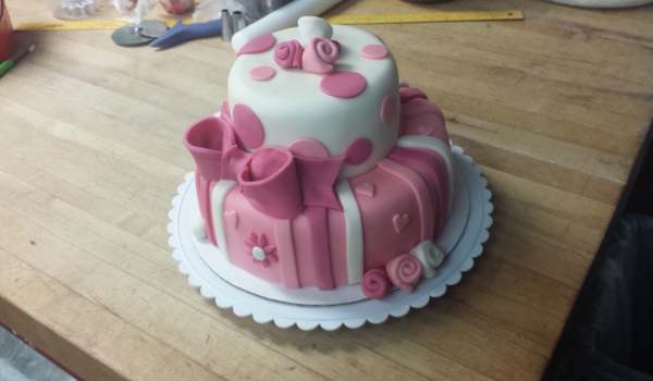 small two tiered pink and white cake