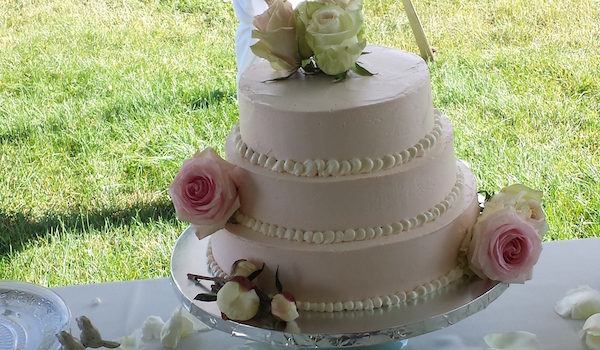 three tiered pink cake with roses