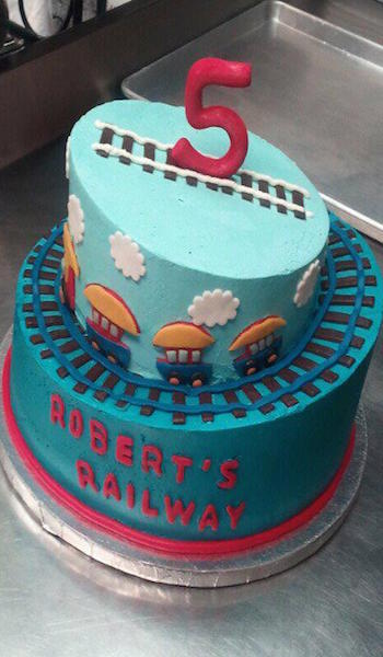 two tiered blue train 5th birthday cake