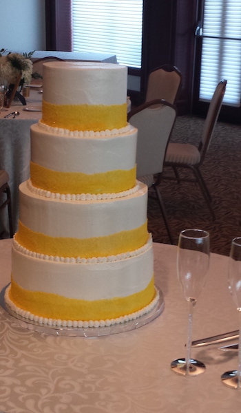 four tiered white and yellow cake