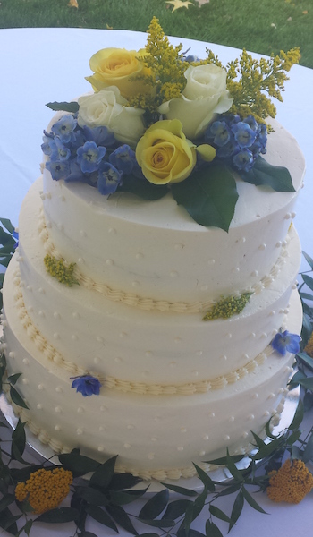 three tiered white cake with flowers